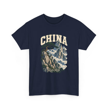 Front view of a Navy Gildan 5000 T-shirt with cream CHINA lettering above a wind-shaped pine, pale granite peaks and clouds, finished with Roots & Roads script.