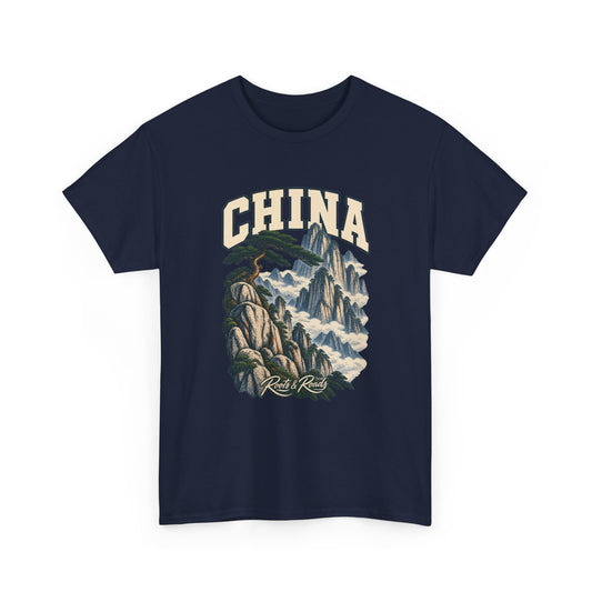 Front view of a Navy Gildan 5000 T-shirt with cream CHINA lettering above a wind-shaped pine, pale granite peaks and clouds, finished with Roots & Roads script.