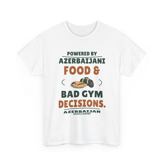 White Azerbaijan T-shirt, front view with “Powered by Azerbaijani food & bad gym decisions.” in retro lettering, herb qutab, a gym bag and weight plate, Azerbaijan label and Roots & Roads signature.