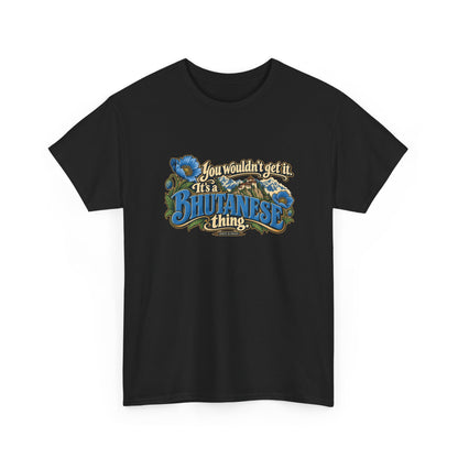 Black Bhutan Bhutanese Thing T-shirt, shaped front view with blue vintage lettering, cream script, blue poppies and a Himalayan monastery; “You wouldn’t get it. It’s a Bhutanese thing.”