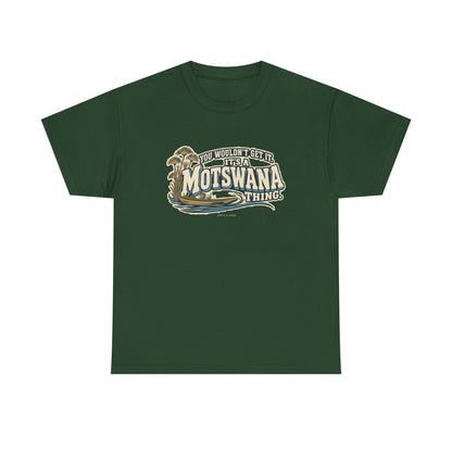 Front view of the Forest Green Motswana Thing T-shirt with “You wouldn’t get it. It’s a Motswana thing.” ivory athletic lettering with blue shadows, an integrated mokoro canoe, papyrus reeds and water lines.