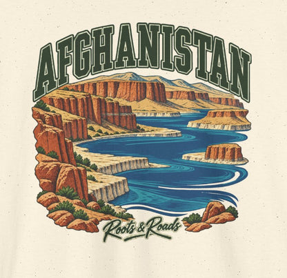 Close-up of Afghanistan Fresh Prints artwork on Natural cotton: forest-green lettering over blue highland lakes and rust-coloured cliffs, with Roots & Roads script.