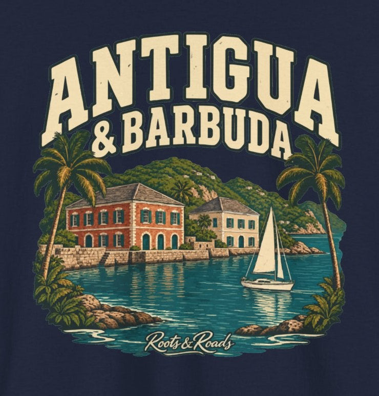 Print detail on Navy cotton with cream ANTIGUA & BARBUDA lettering, a sailboat on teal harbour water, waterfront buildings, palms, and Roots & Roads script.