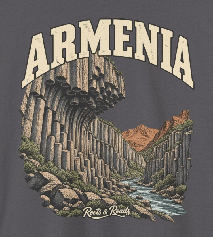 Print detail on Charcoal fabric showing ARMENIA lettering, curved basalt columns, rocky stream, warm hills and Roots & Roads signature.