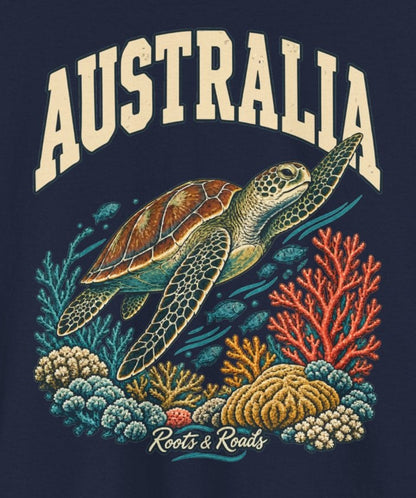 Print detail on Navy cotton showing cream AUSTRALIA lettering above a sea turtle, teal and coral reef details, small fish, and Roots & Roads script.