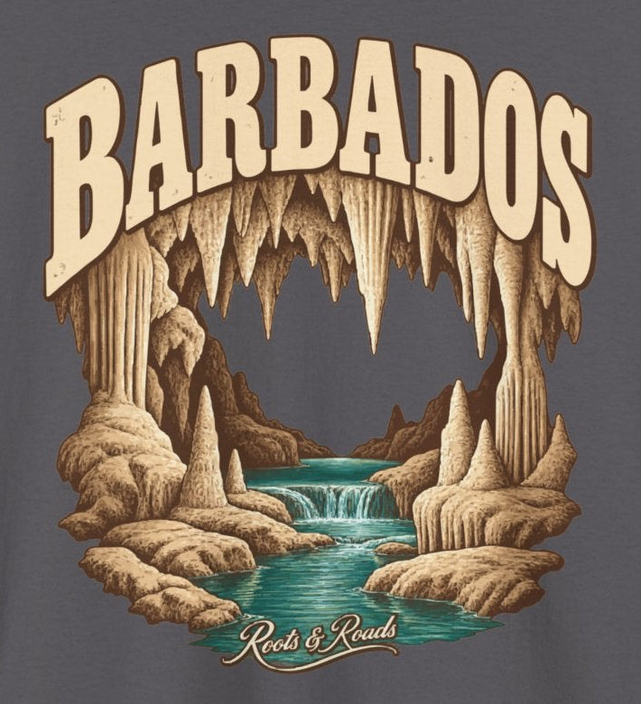 Print detail on Charcoal cotton showing BARBADOS lettering, stalactites and limestone formations around a turquoise stream, with Roots & Roads script.