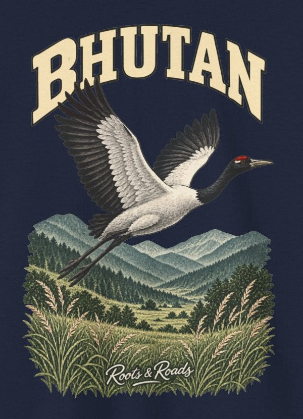 Print detail on Navy cotton showing BHUTAN lettering, a black-necked crane, layered hills, valley grasses and Roots & Roads signature.