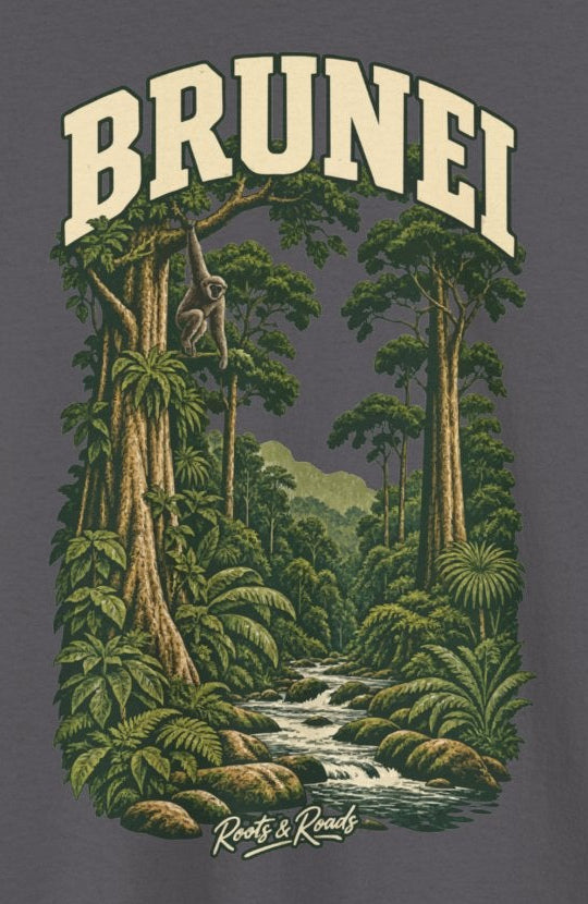 Print detail on Charcoal cotton showing BRUNEI lettering, a gibbon, rainforest trees, green foliage, a stream and Roots & Roads signature.