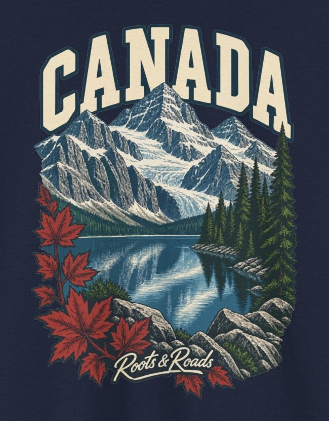 Print detail cropped from the Navy Canada supplier T-shirt mockup, showing cream CANADA lettering above snow-lined peaks, a blue lake, conifers and red maple leaves and Roots & Roads script.