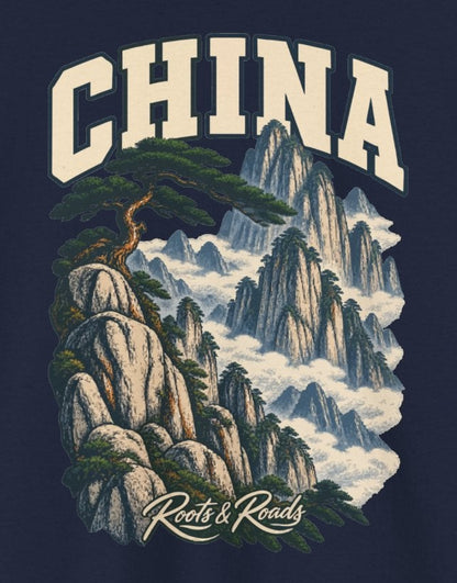 Print detail cropped from the Navy China supplier T-shirt mockup, showing cream CHINA lettering above a wind-shaped pine, pale granite peaks and clouds and Roots & Roads script.