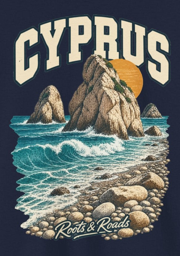 Print detail on Navy cotton showing cream CYPRUS lettering, sea rocks, turquoise waves, a pebble beach, warm sun and Roots & Roads script.