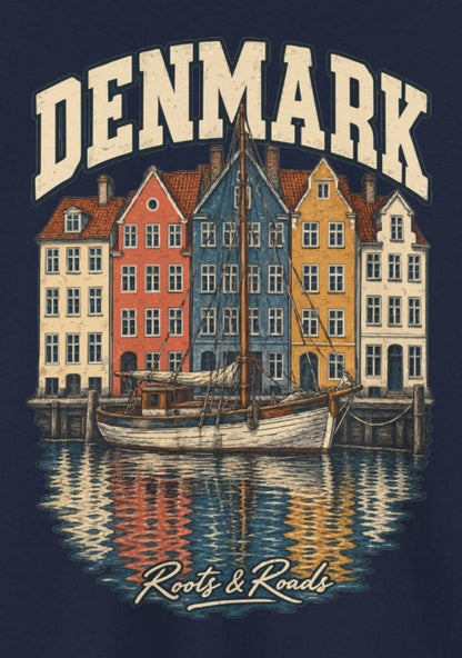 Print detail on Navy cotton showing cream DENMARK lettering, colourful harbour houses, a sailing vessel, reflections and Roots & Roads script.