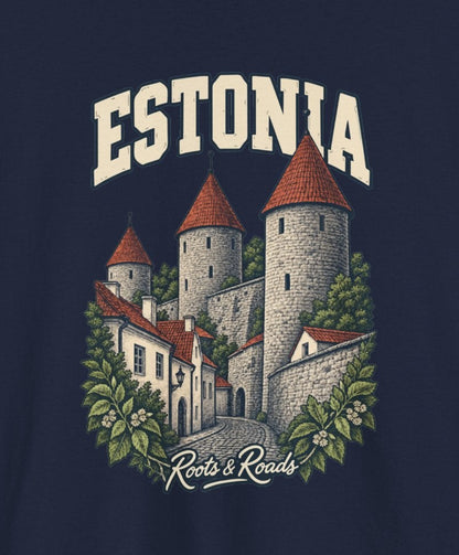 Print detail cropped from the Navy Estonia supplier T-shirt mockup, showing cream ESTONIA lettering, red-roofed stone towers, a town wall and leafy branches and Roots & Roads script.