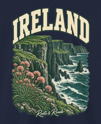 Print detail on the Navy Ireland supplier T-shirt mockup: country lettering, green sea cliffs, Atlantic waves and pink coastal flowers, and Roots & Roads script.