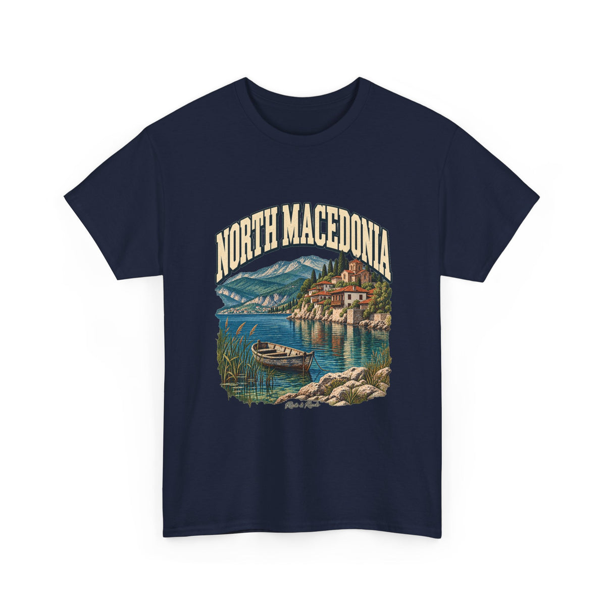 Front view of a Navy Gildan 5000 T-shirt with NORTH MACEDONIA lettering, a mountain lake, wooden boat, red-roofed waterfront buildings and reeds, and Roots & Roads script.