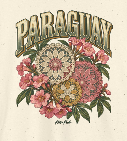 Print detail of PARAGUAY lettering, cream pink and ochre lace rosettes, pink flowers, green leaves and the original Roots & Roads script on Natural cotton.