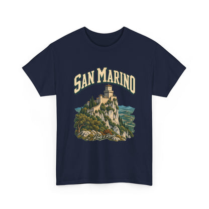 Front view of the navy Gildan 5000 San Marino Fresh Prints T-shirt, with cream SAN MARINO lettering, a stone fortress and mountain landscape, and Roots & Roads signature.