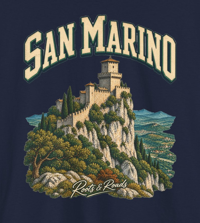 Print detail on the navy San Marino Fresh Prints T-shirt, with cream SAN MARINO lettering, a stone fortress and mountain landscape, and Roots & Roads signature.