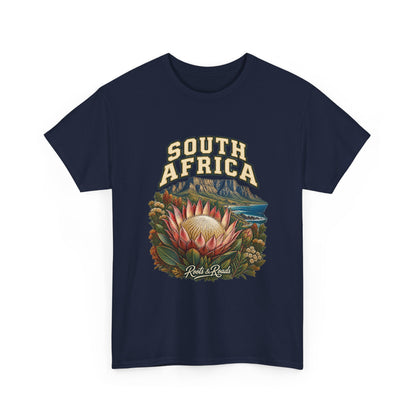 Front view of the South Africa Fresh Prints T-shirt in Navy, featuring cream country lettering, a pink protea, coastal mountains and foliage.