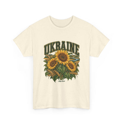 Front view of a Natural Gildan 5000 Ukraine T-shirt with dark green UKRAINE lettering, golden sunflowers, wheat, green leaves, a winding river and Roots & Roads script.